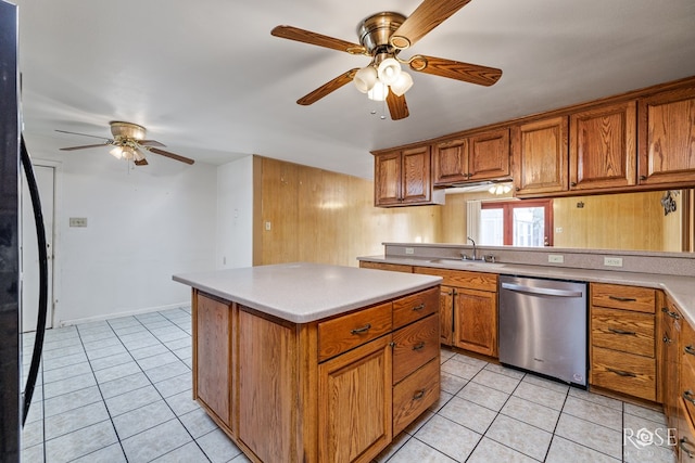 kitchen with sink, dishwasher, a center island, black fridge, and light tile patterned flooring