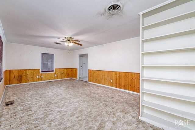 carpeted empty room with a textured ceiling and ceiling fan