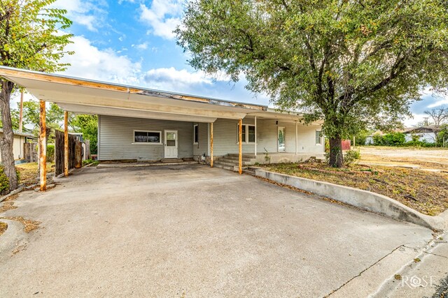 ranch-style home featuring a carport