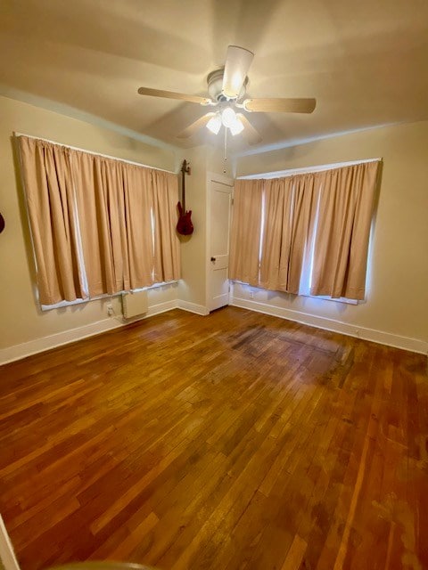 925 E 40th St, San Angelo, TX 76903 - spare room featuring ceiling fan, dark wood finished floors, and baseboards