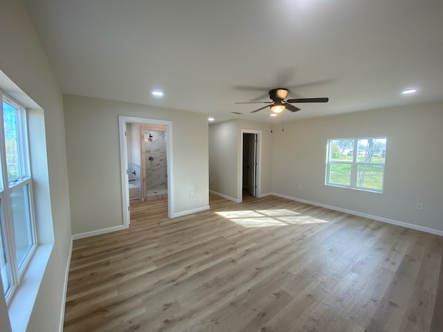 unfurnished bedroom with multiple windows, light hardwood / wood-style floors, and ceiling fan