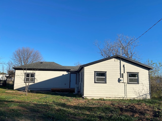 rear view of property with a lawn