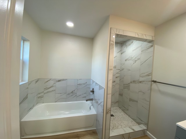 bathroom with separate shower and tub and hardwood / wood-style floors