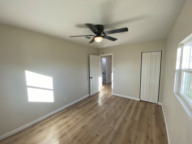 unfurnished bedroom with a closet, ceiling fan, and light hardwood / wood-style flooring