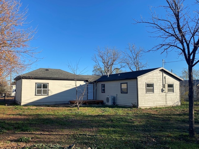 back of house featuring a lawn and ac unit