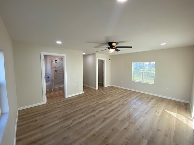 unfurnished bedroom with ceiling fan, hardwood / wood-style floors, and a walk in closet