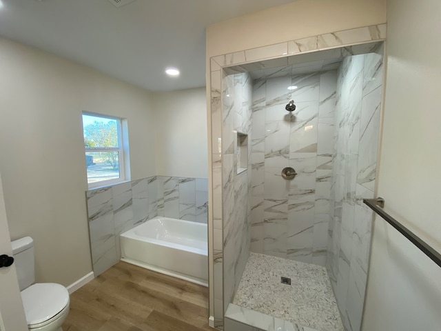 bathroom with hardwood / wood-style flooring, independent shower and bath, and toilet