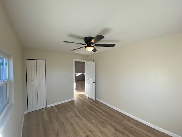 unfurnished bedroom featuring a closet, ceiling fan, and light hardwood / wood-style floors