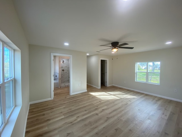 unfurnished room with ceiling fan, a healthy amount of sunlight, and light hardwood / wood-style floors