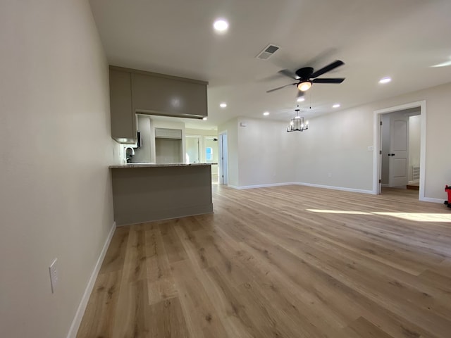 unfurnished living room with ceiling fan and light wood-type flooring