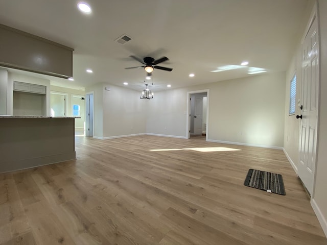 unfurnished living room featuring ceiling fan and light hardwood / wood-style floors