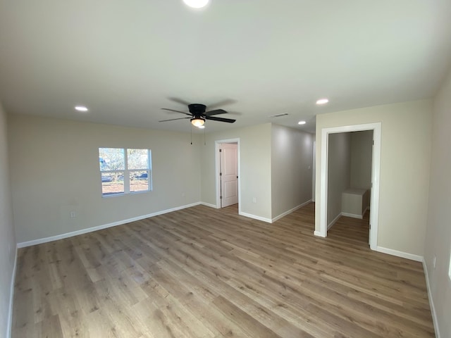 empty room featuring ceiling fan and light hardwood / wood-style flooring