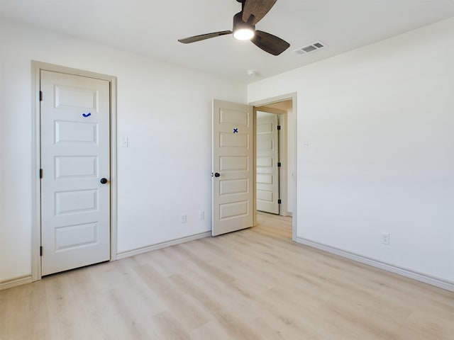 spare room featuring light hardwood / wood-style floors and ceiling fan