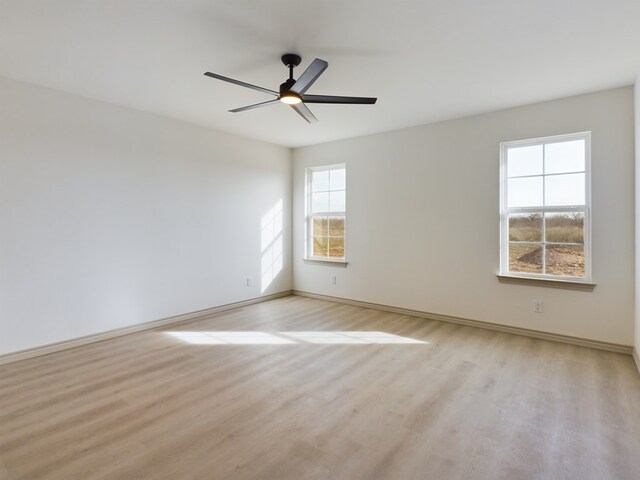 unfurnished room with ceiling fan and light hardwood / wood-style flooring