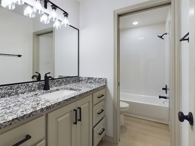 full bathroom featuring vanity, wood-type flooring, bathing tub / shower combination, and toilet