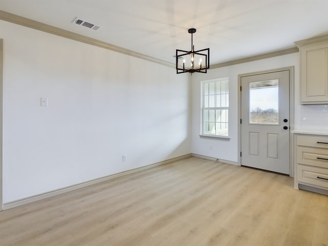 unfurnished dining area featuring ornamental molding, a notable chandelier, and light wood-type flooring