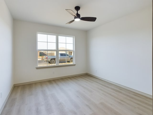 spare room featuring light hardwood / wood-style flooring and ceiling fan