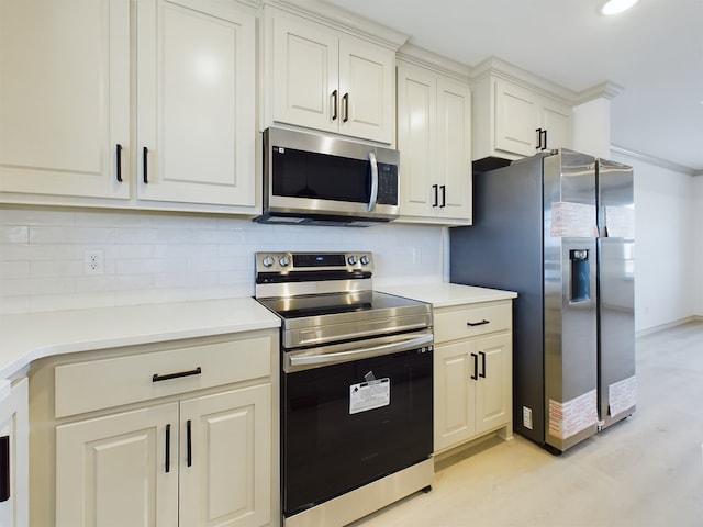 kitchen with decorative backsplash, light hardwood / wood-style floors, and appliances with stainless steel finishes