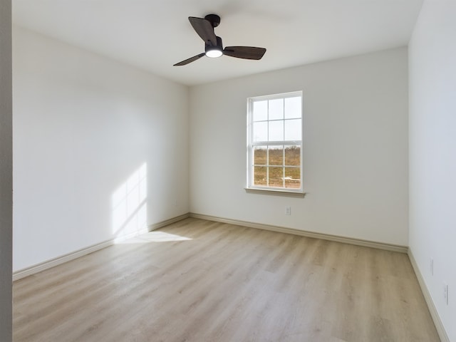 spare room featuring light hardwood / wood-style floors and ceiling fan