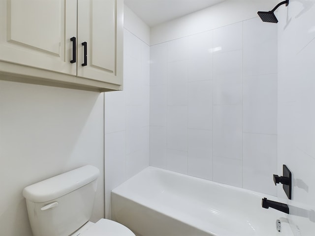 bathroom featuring tiled shower / bath and toilet