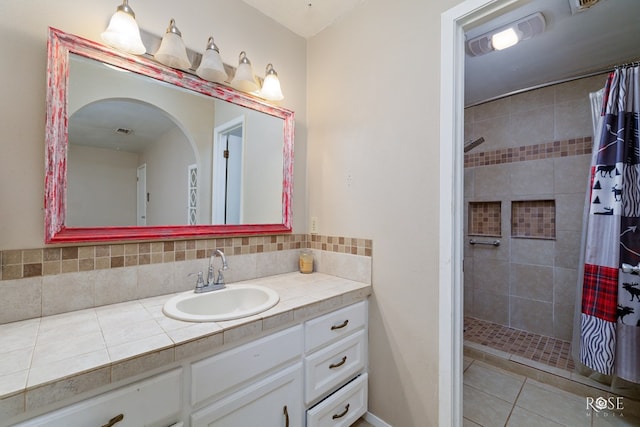 bathroom featuring tasteful backsplash, vanity, curtained shower, and tile patterned flooring