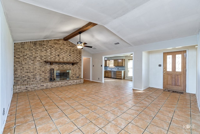 unfurnished living room with light tile patterned floors, ceiling fan, lofted ceiling with beams, brick wall, and a brick fireplace