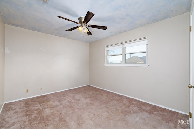 unfurnished room with ceiling fan and light carpet