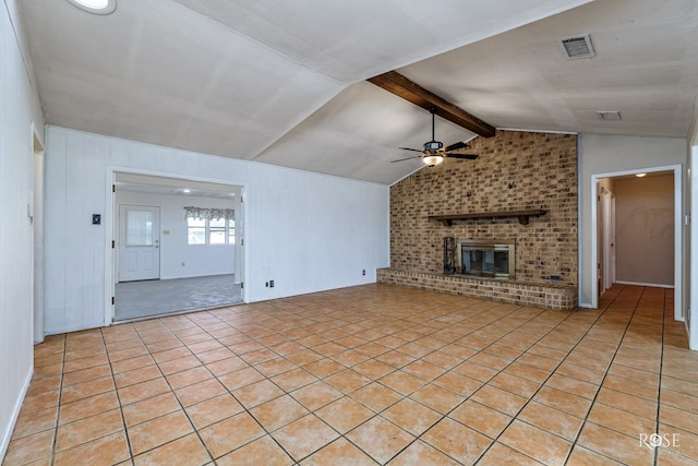 unfurnished living room featuring light tile patterned flooring, a brick fireplace, vaulted ceiling with beams, and ceiling fan