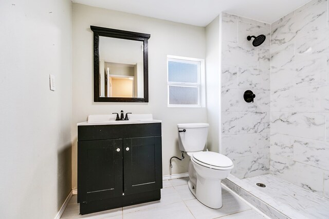 106 W 27th St, San Angelo, TX 76903 - bathroom with a tile shower, vanity, and tile patterned flooring