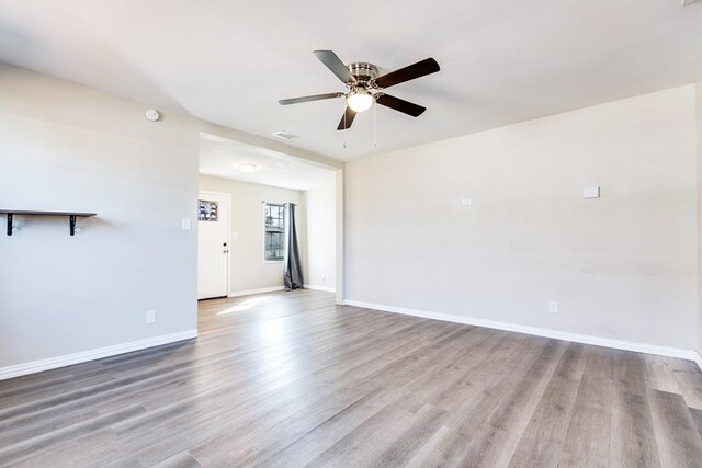 106 W 27th St, San Angelo, TX 76903 - unfurnished living room with ceiling fan and wood finished floors