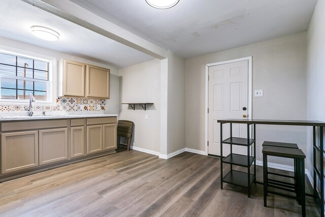 106 W 27th St, San Angelo, TX 76903 - kitchen featuring light wood-style flooring, light countertops, and tasteful backsplash