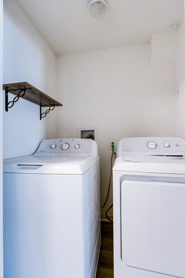 106 W 27th St, San Angelo, TX 76903 - laundry room featuring washing machine and dryer and dark wood finished floors