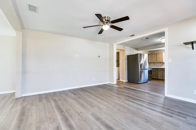 106 W 27th St, San Angelo, TX 76903 - unfurnished living room featuring ceiling fan and light wood-style flooring