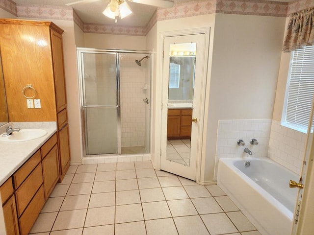 full bath with tile patterned floors, a shower stall, ceiling fan, a garden tub, and vanity