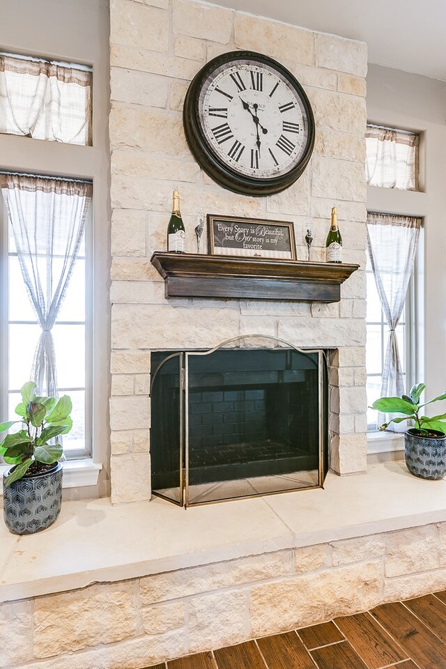 details with hardwood / wood-style floors and a fireplace