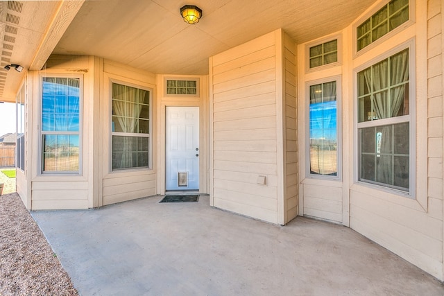 property entrance featuring a patio area