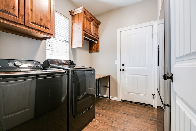 laundry room featuring washer and clothes dryer, cabinets, and plenty of natural light