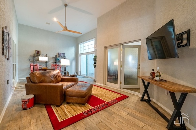 living room featuring hardwood / wood-style floors and a high ceiling