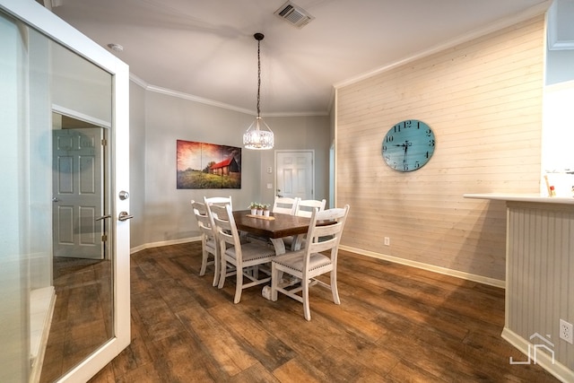 dining room with crown molding and dark hardwood / wood-style floors