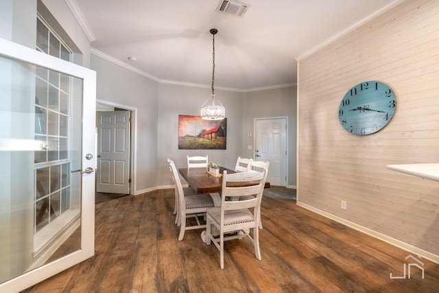 dining space with ornamental molding and dark hardwood / wood-style flooring