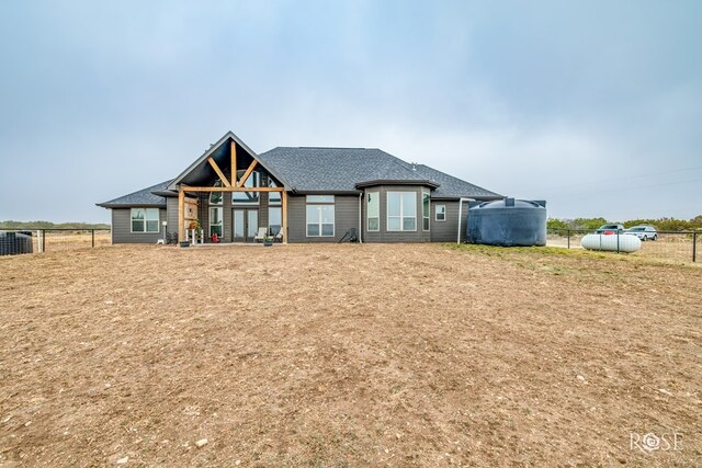 view of front of property with cooling unit and a front yard