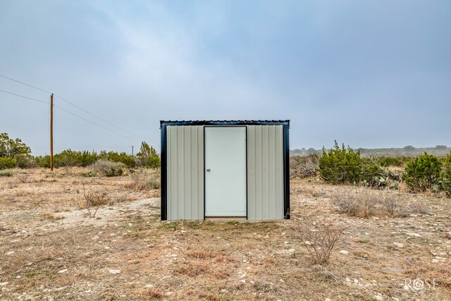 view of outbuilding featuring a rural view