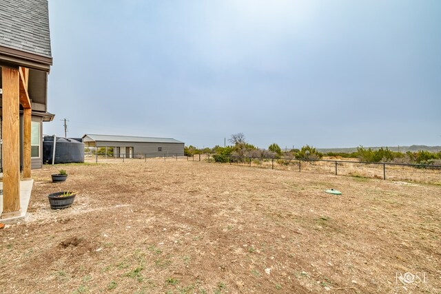 view of yard with a rural view