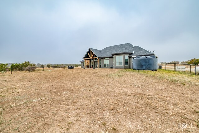 back of property with a rural view