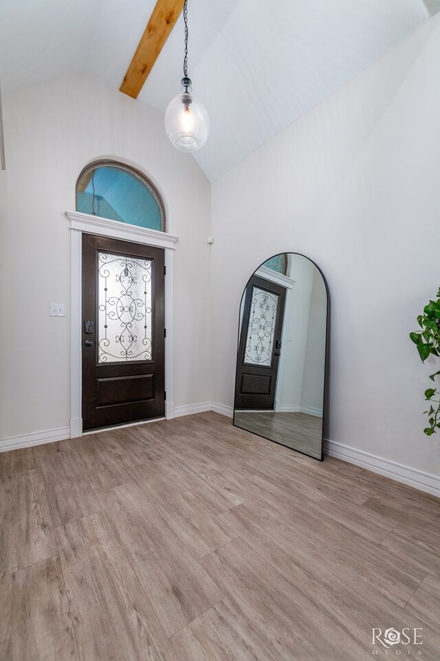 foyer with beamed ceiling, high vaulted ceiling, and light hardwood / wood-style flooring