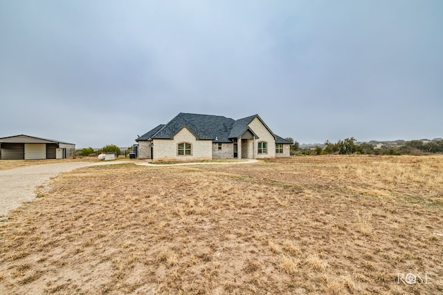 french provincial home featuring an outbuilding and a garage