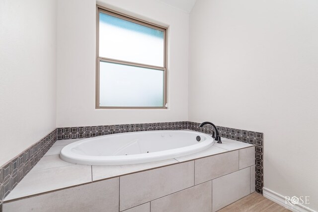 bathroom featuring tiled bath