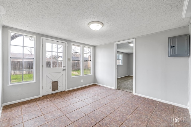 interior space featuring tile patterned floors, electric panel, and a textured ceiling