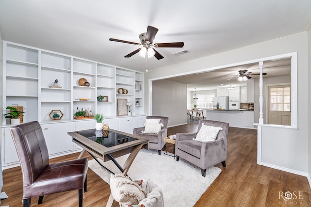 office area with ceiling fan and dark wood-type flooring