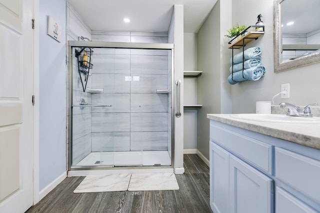 419 N Emerson St, San Angelo, TX 76903 - full bathroom featuring wood finished floors, a stall shower, baseboards, and recessed lighting